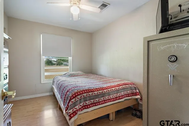 a bedroom with a bed and a window