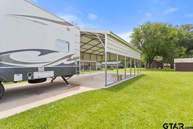 a view of a house with backyard porch and sitting area