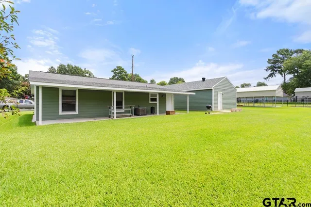a front view of house with yard and swimming pool