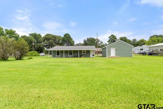 a house with swimming pool in front of it