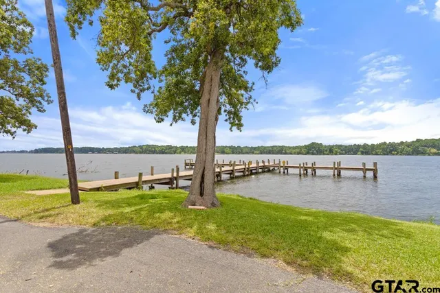 a view of a lake with a table and chairs