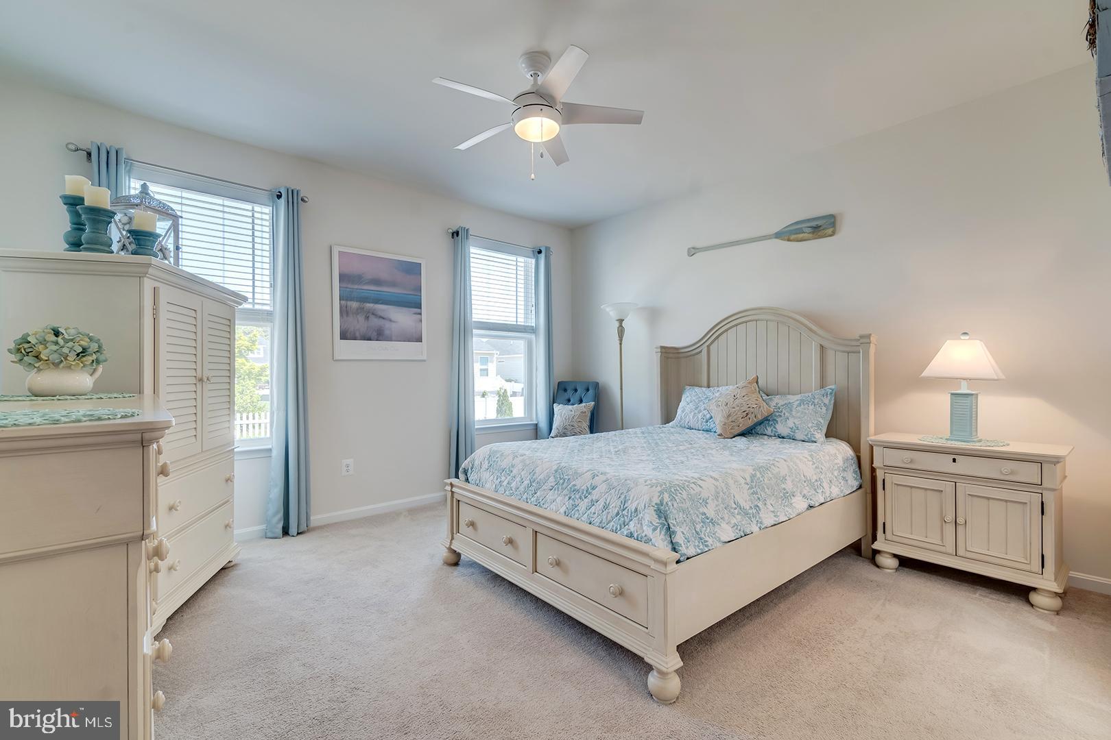 34438 Spring Brook Avenue Lewes, DE 19958 - Photo 4 of 58 a bedroom with a bed and a chandelier
