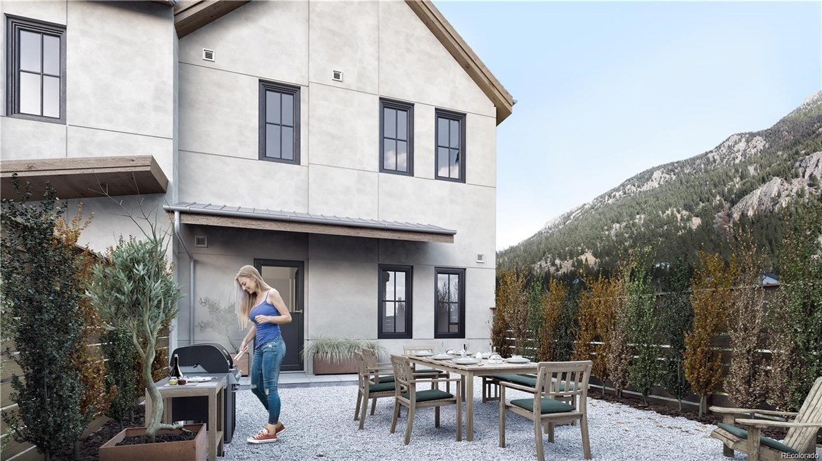 611 Blue Spruce Lane, Unit 150 Georgetown, CO 80444 - Photo 1 of 10 a view of a patio with table and chairs and potted plants