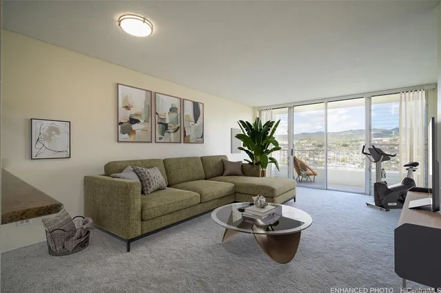 a living room with furniture and a floor to ceiling window