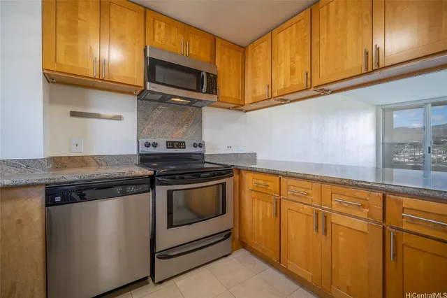 a kitchen with granite countertop cabinets stainless steel appliances and a sink