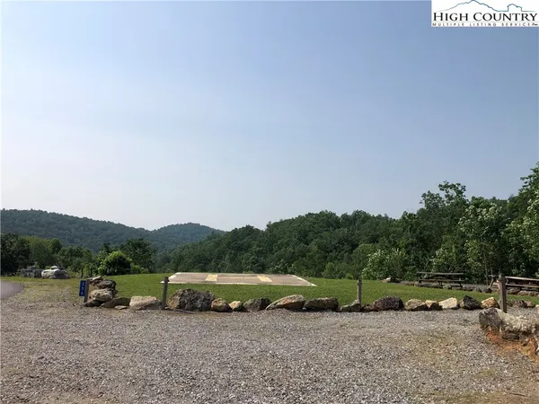 a group of cars parked in the middle of a field