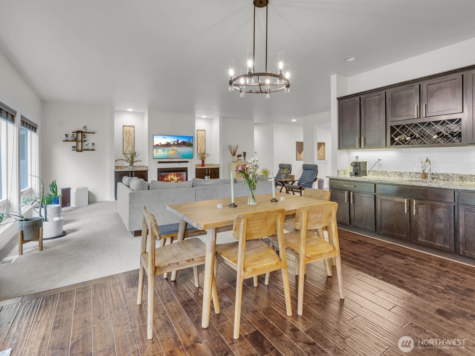 12503 Southeast 104th Street Renton, WA 98056 - Photo 12 of 37 a view of a dining room with furniture wooden floor and chandelier