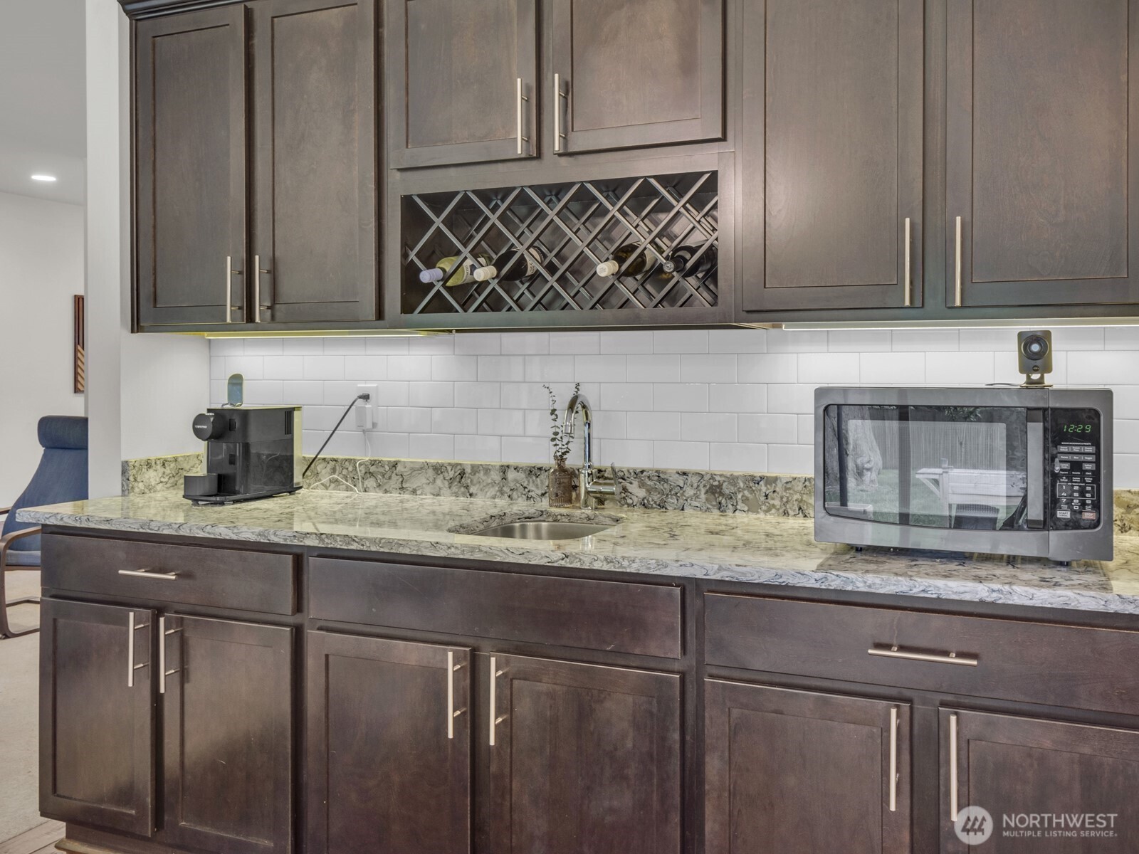 12503 Southeast 104th Street Renton, WA 98056 - Photo 13 of 37 a kitchen with granite countertop a sink and cabinets