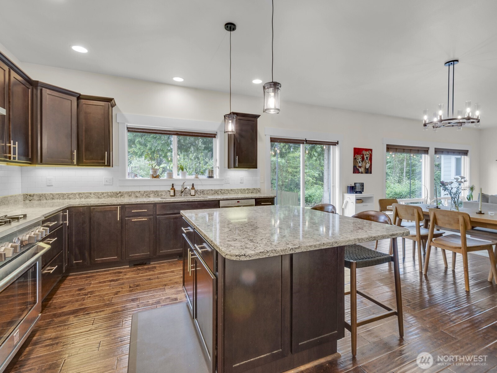 12503 Southeast 104th Street Renton, WA 98056 - Photo 16 of 37 a kitchen with stainless steel appliances granite countertop a sink stove and refrigerator