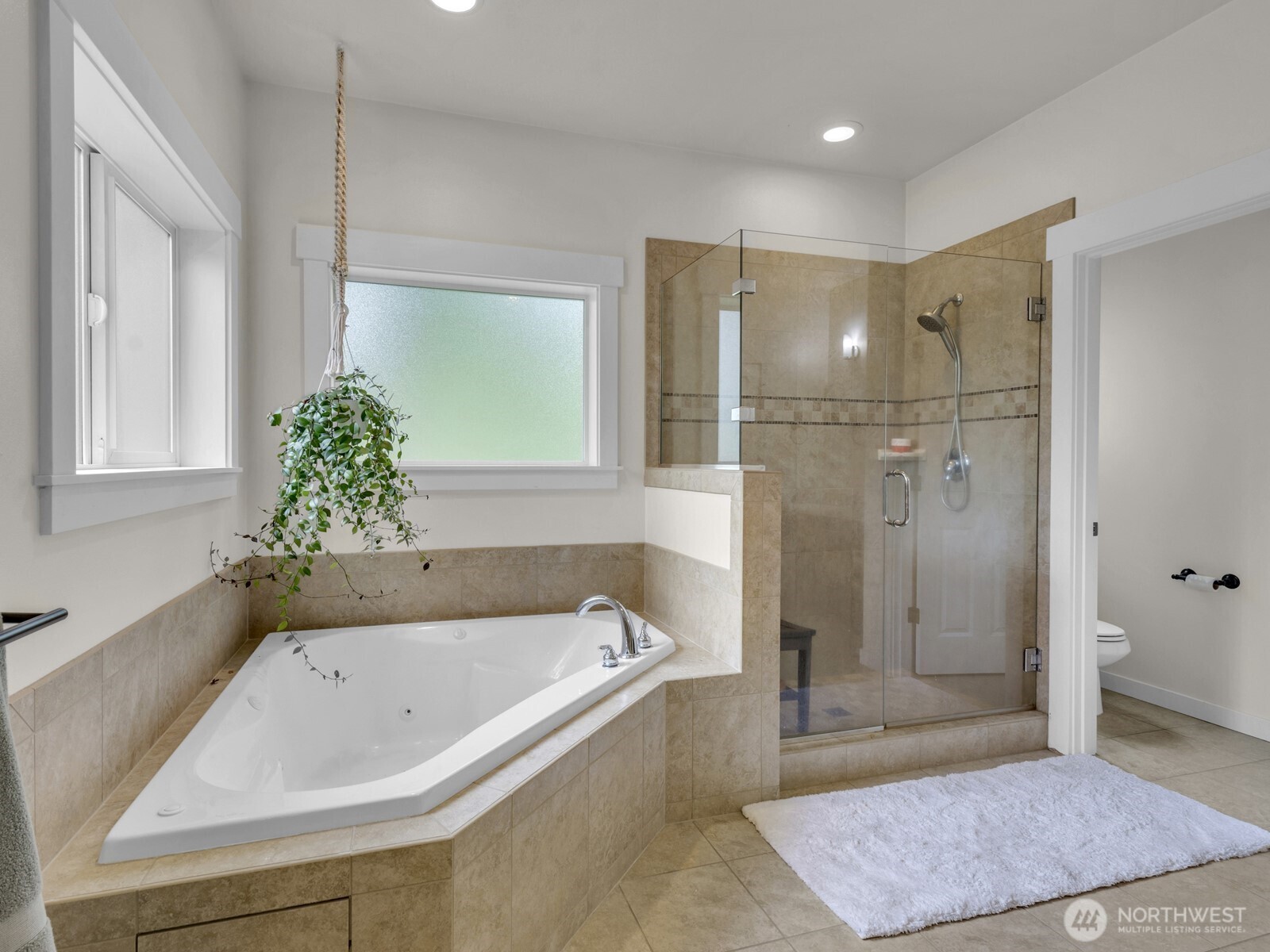 12503 Southeast 104th Street Renton, WA 98056 - Photo 21 of 37 a bathroom with a bathtub and shower