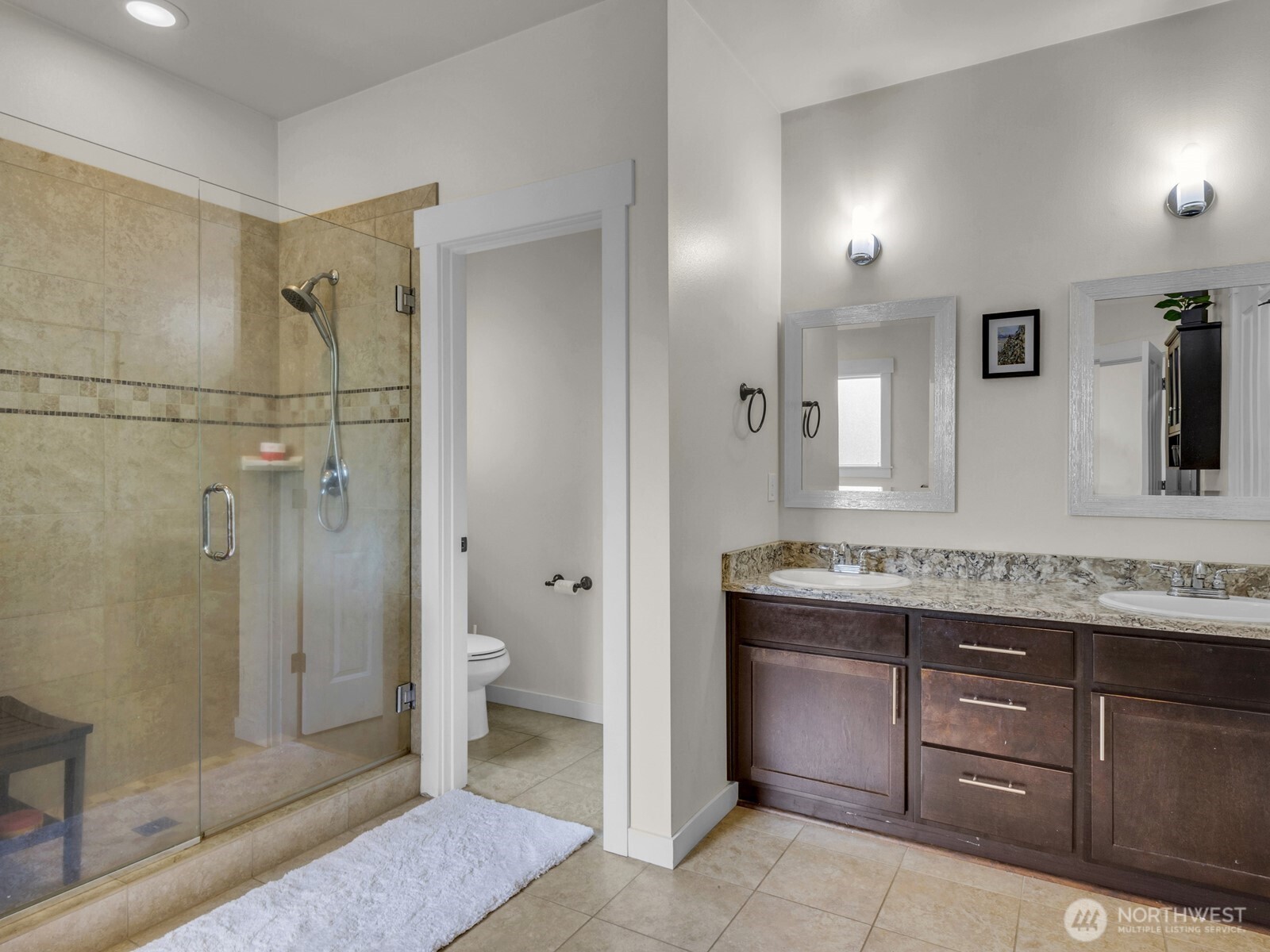 12503 Southeast 104th Street Renton, WA 98056 - Photo 22 of 37 a bathroom with a granite countertop sink toilet mirror and shower