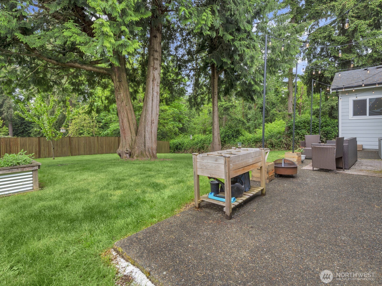 12503 Southeast 104th Street Renton, WA 98056 - Photo 31 of 37 a backyard of a house with table and chairs