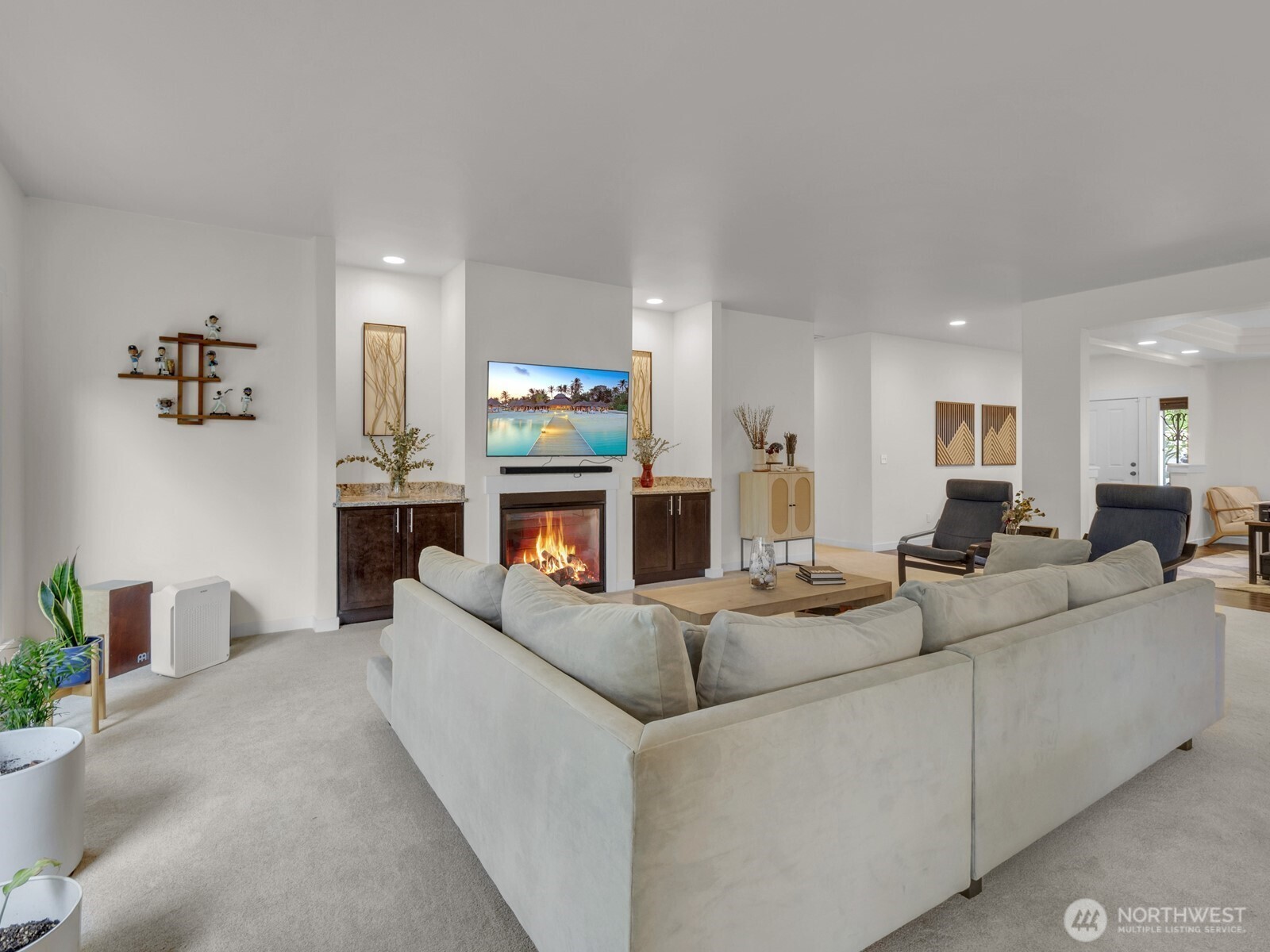 12503 Southeast 104th Street Renton, WA 98056 - Photo 7 of 37 a living room with furniture a fireplace and a flat screen tv