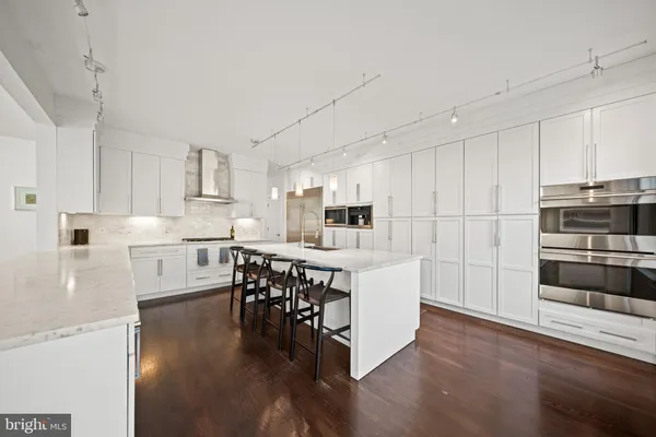 a spacious bathroom with a granite countertop sink and a mirror