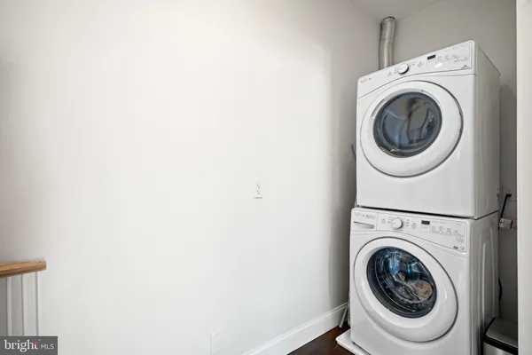 a bathroom with a sink a toilet a mirror and shower