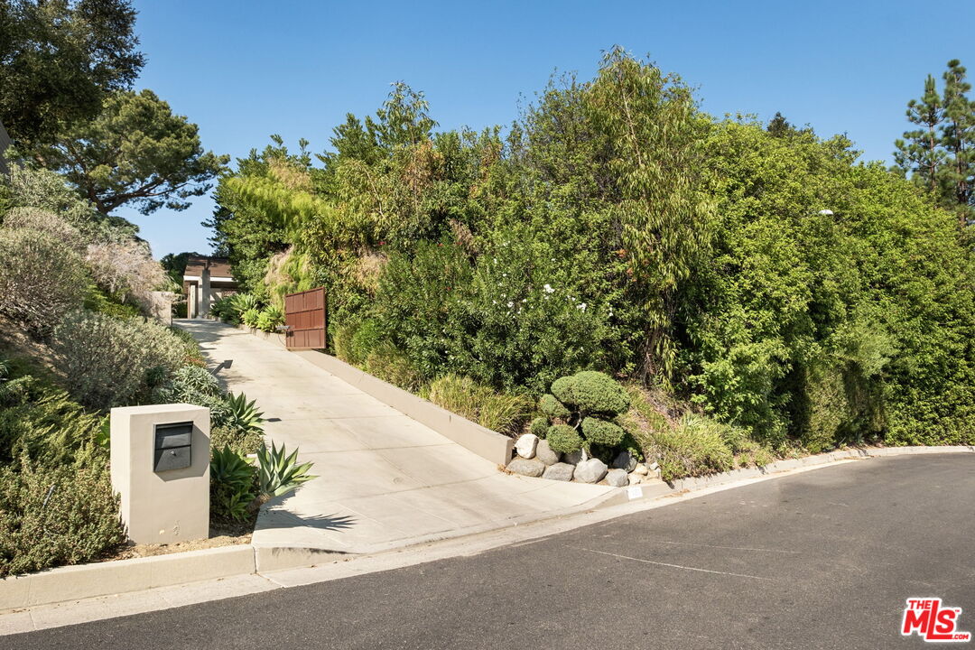 1161 Romney Drive Pasadena, CA 91105 - Photo 2 of 29 a view of a street with a trees in the background