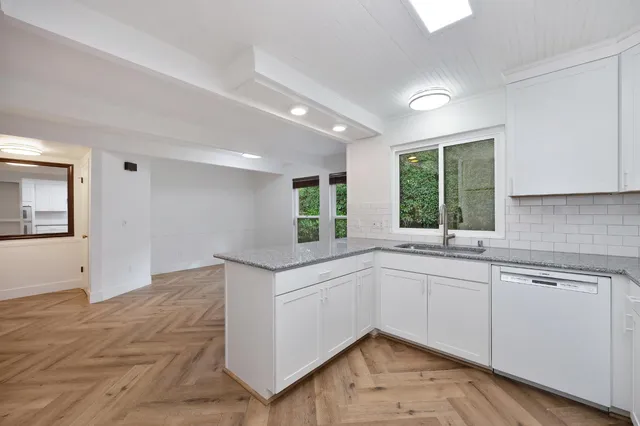 a view of a garden with lawn chairs and a yard