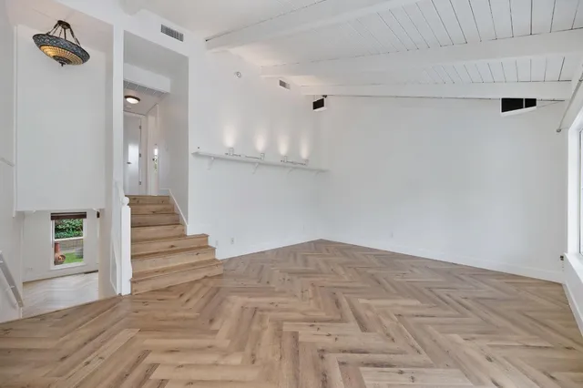 an empty room with windows and closet