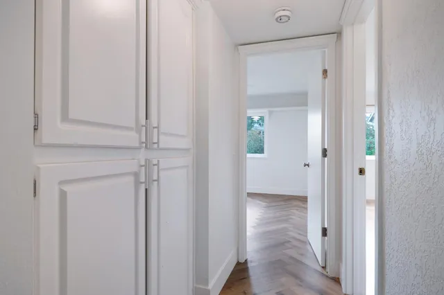 a bathroom with a sink a glass door shower and a mirror
