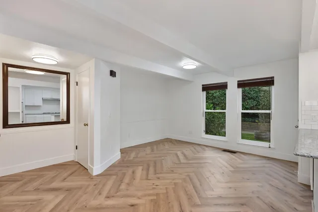 a view of a kitchen with wooden floor and electronic appliances