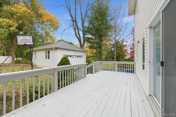 a view of a wooden deck and a yard with wooden fence