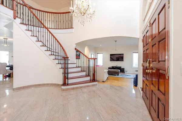 a view of a livingroom with wooden floor and stairs