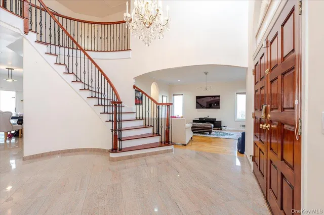a view of a livingroom with wooden floor and stairs