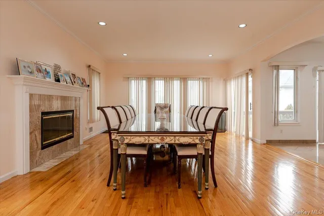 a view of a a dining room with furniture window and wooden floor