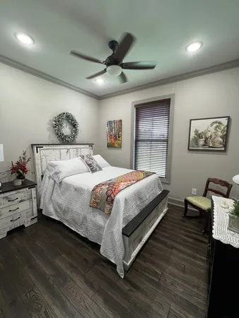a bedroom with a bed and a chandelier