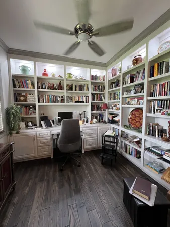 a living room with furniture and a book shelf