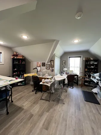 a living room with furniture a table and a wooden floor