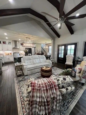 a bedroom with furniture and a wooden floor