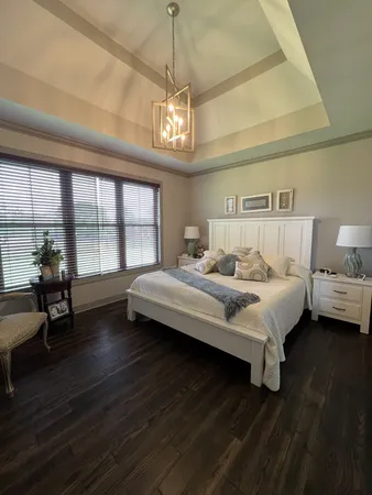 a bedroom with bed and wooden floor