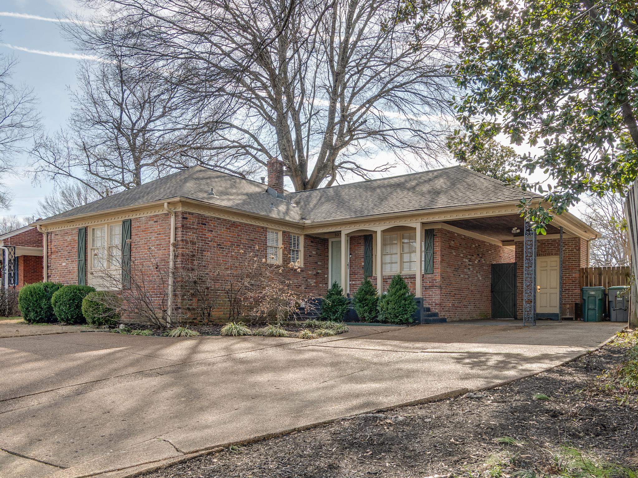 337 North White Station Road Memphis, TN 38117 - Photo 1 of 37 Ranch-style home with concrete driveway, brick siding, a chimney, and an attached carport