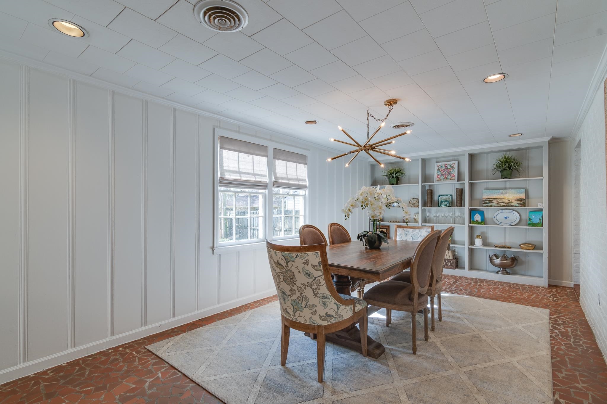 337 North White Station Road Memphis, TN 38117 - Photo 12 of 37 Dining space with visible vents, ornamental molding, built in shelves, a decorative wall, and a notable chandelier