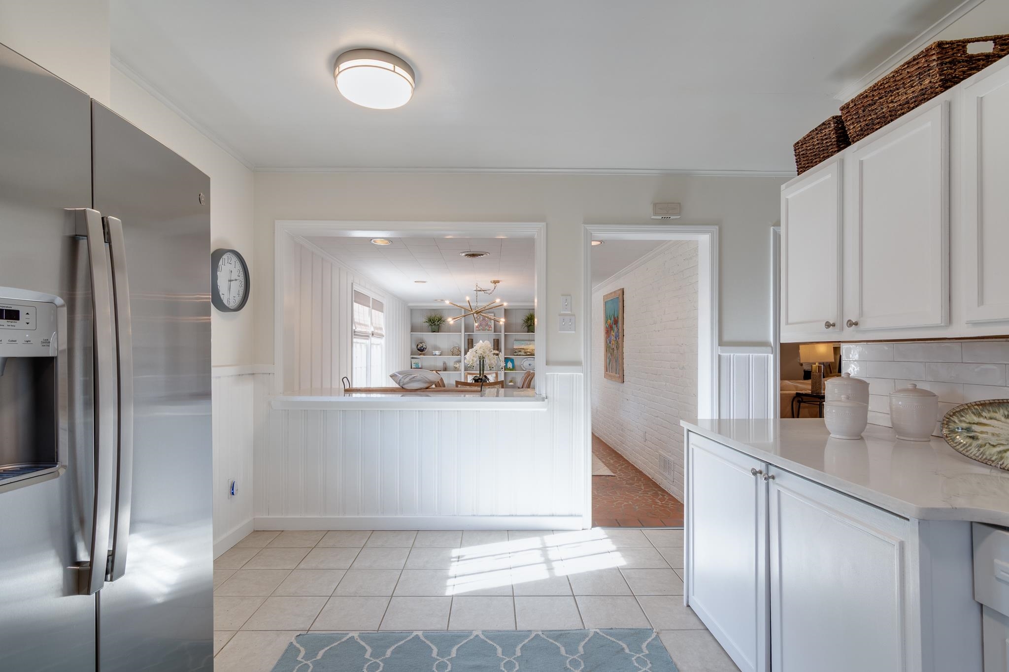 337 North White Station Road Memphis, TN 38117 - Photo 16 of 37 Kitchen with white cabinetry, stainless steel refrigerator with ice dispenser, light countertops, and wainscoting