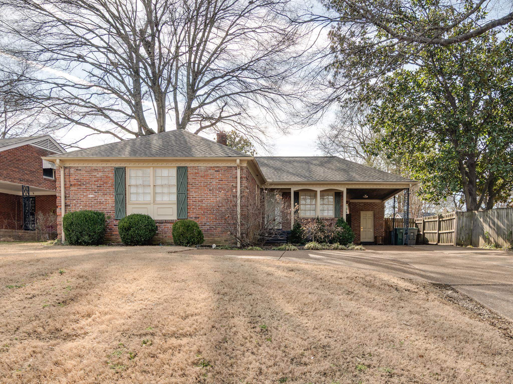 337 North White Station Road Memphis, TN 38117 - Photo 2 of 37 Ranch-style home with fence, a front lawn, concrete driveway, and brick siding