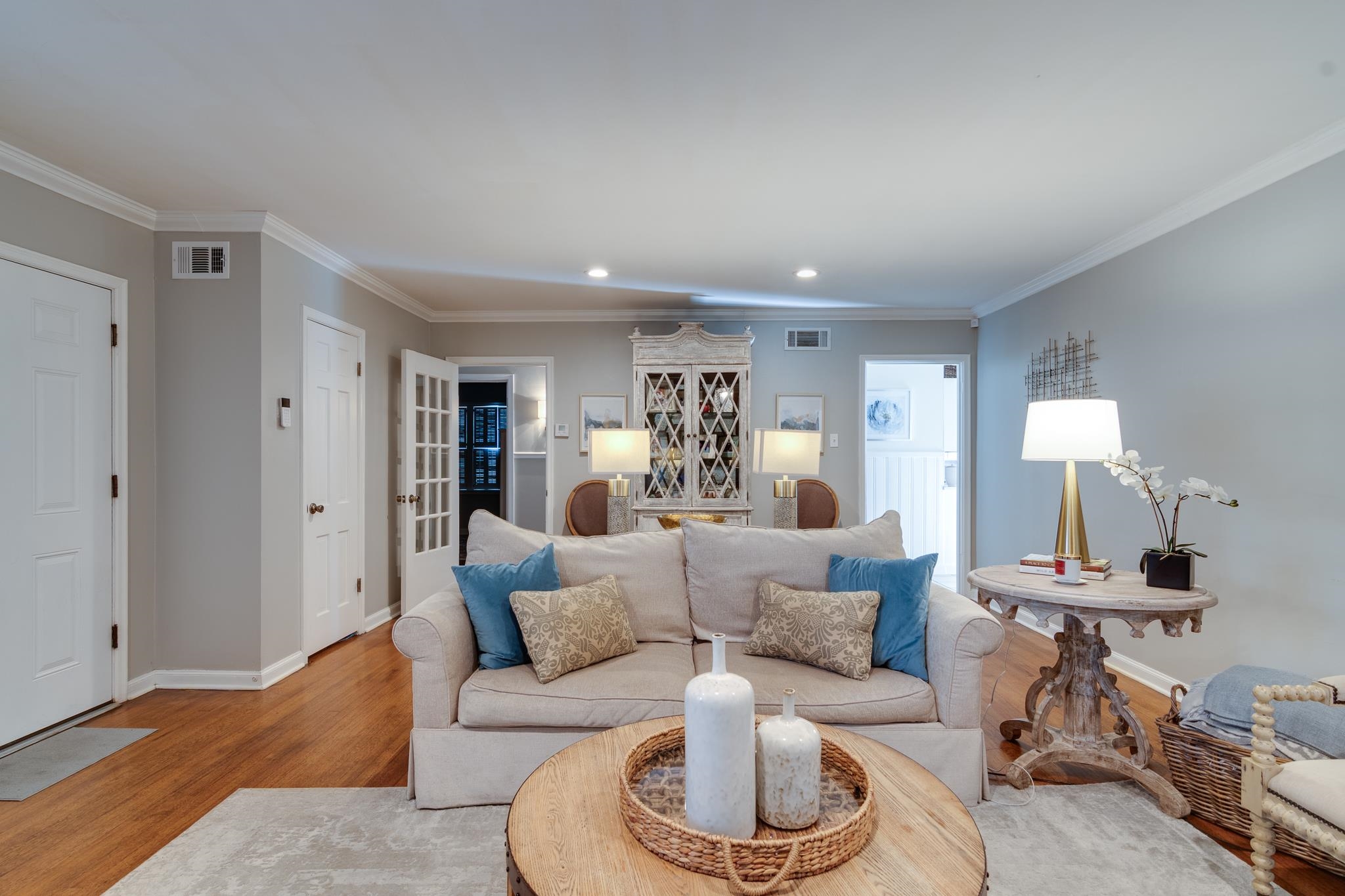 337 North White Station Road Memphis, TN 38117 - Photo 7 of 37 Living room featuring ornamental molding, visible vents, light wood-style flooring, and baseboards