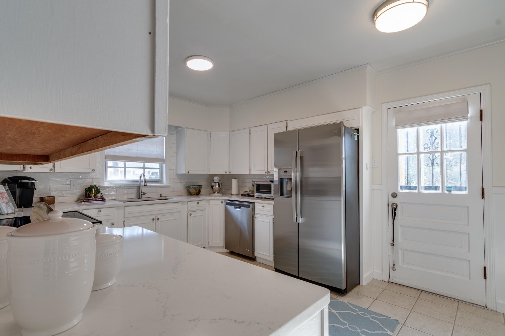 337 North White Station Road Memphis, TN 38117 - Photo 8 of 37 Kitchen with light tile patterned floors, appliances with stainless steel finishes, white cabinetry, a sink, and light stone countertops