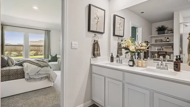 a en suite bathroom with double sink and a mirror