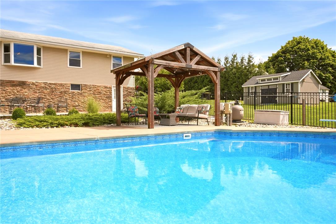 463 North Penn Dixie Road Bath, PA 18014 - Photo 62 of 86 An inviting in-ground pool awaits, complemented by a shaded pergola perfect for outdoor lounging.