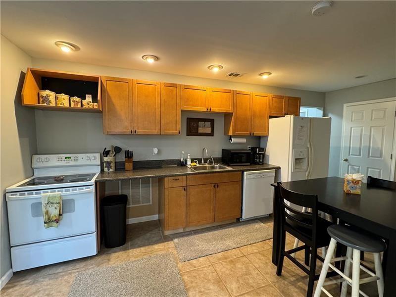 415 Holland Springs Drive Northwest, Unit TERRAC Powder Springs, GA 30127 - Photo 11 of 24 a kitchen with a stove a sink and a microwave