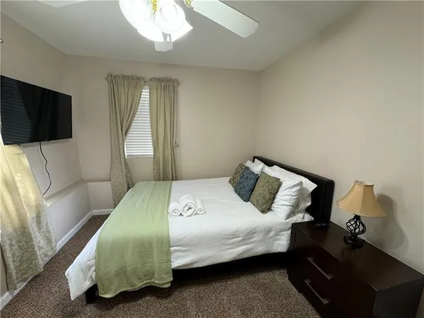 a bedroom with a bed and flat screen tv