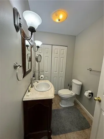 a bathroom with a sink a toilet and a mirror