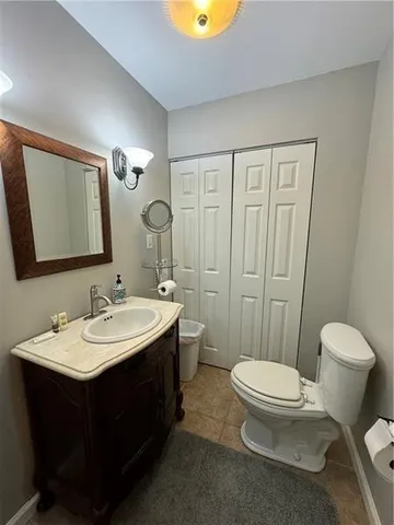a bathroom with a toilet a sink and mirror