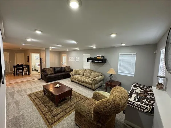a living room with furniture rug and a table