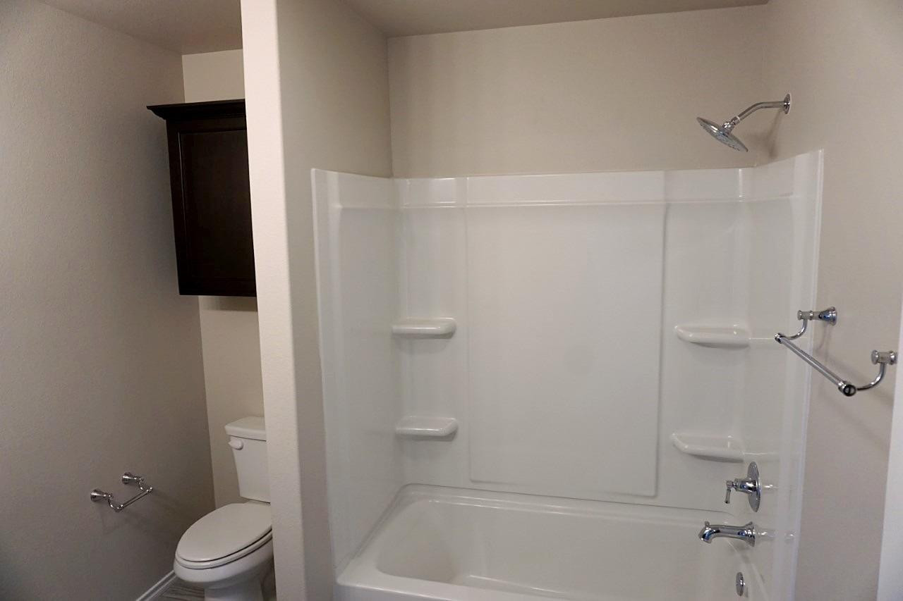 6822 40th Street Lubbock, TX 79407 - Photo 10 of 10 a bathroom with a shower and a toilet