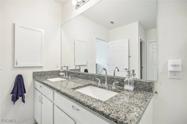 a bedroom with a bed and a chair