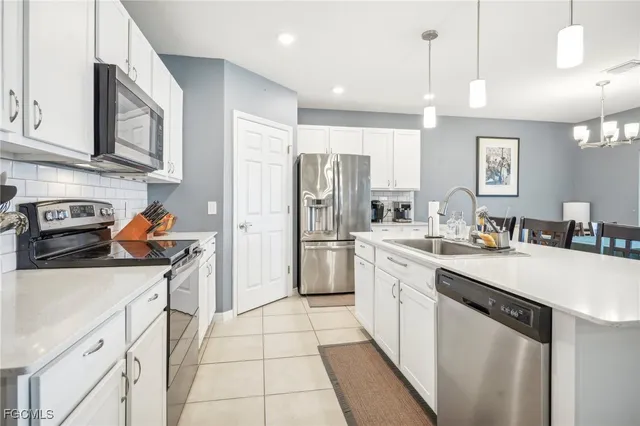 a kitchen with stainless steel appliances a refrigerator sink and cabinets