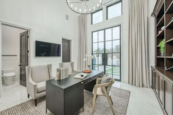 a living room with furniture and a floor to ceiling window